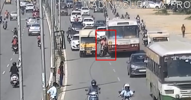 Biker & pillion miraculously escape from getting crushed under a bus [Video]