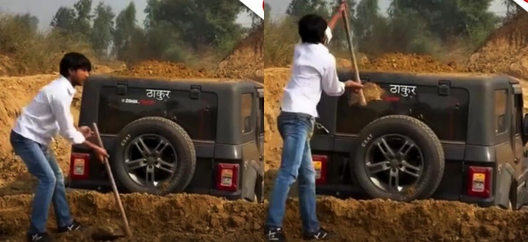 Man puts dirt on top of thar